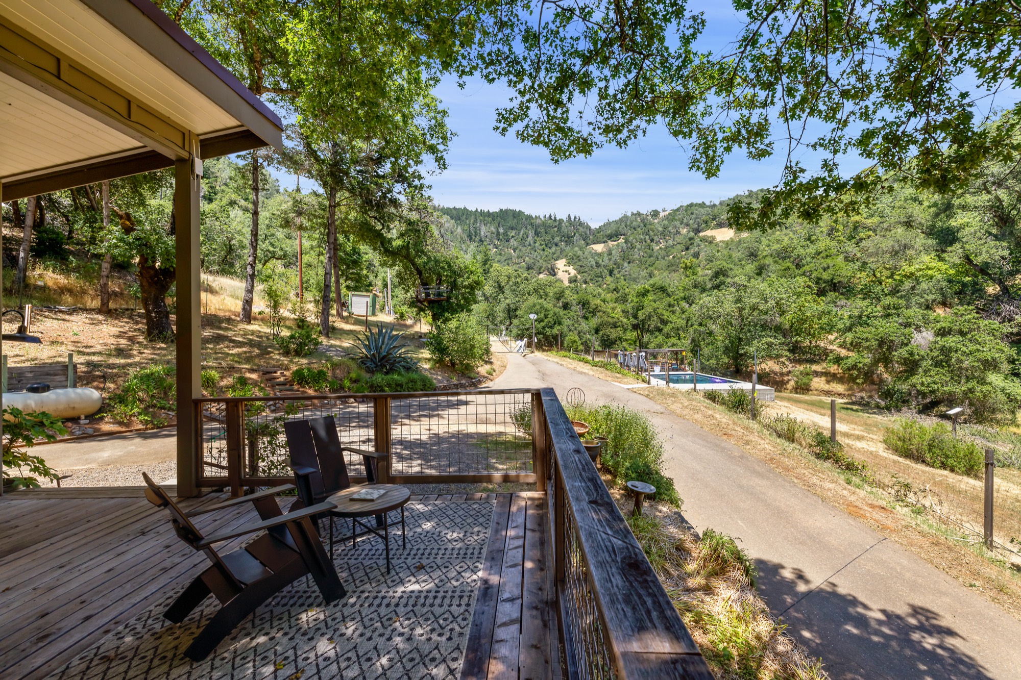 Deck with views of pool and hillside