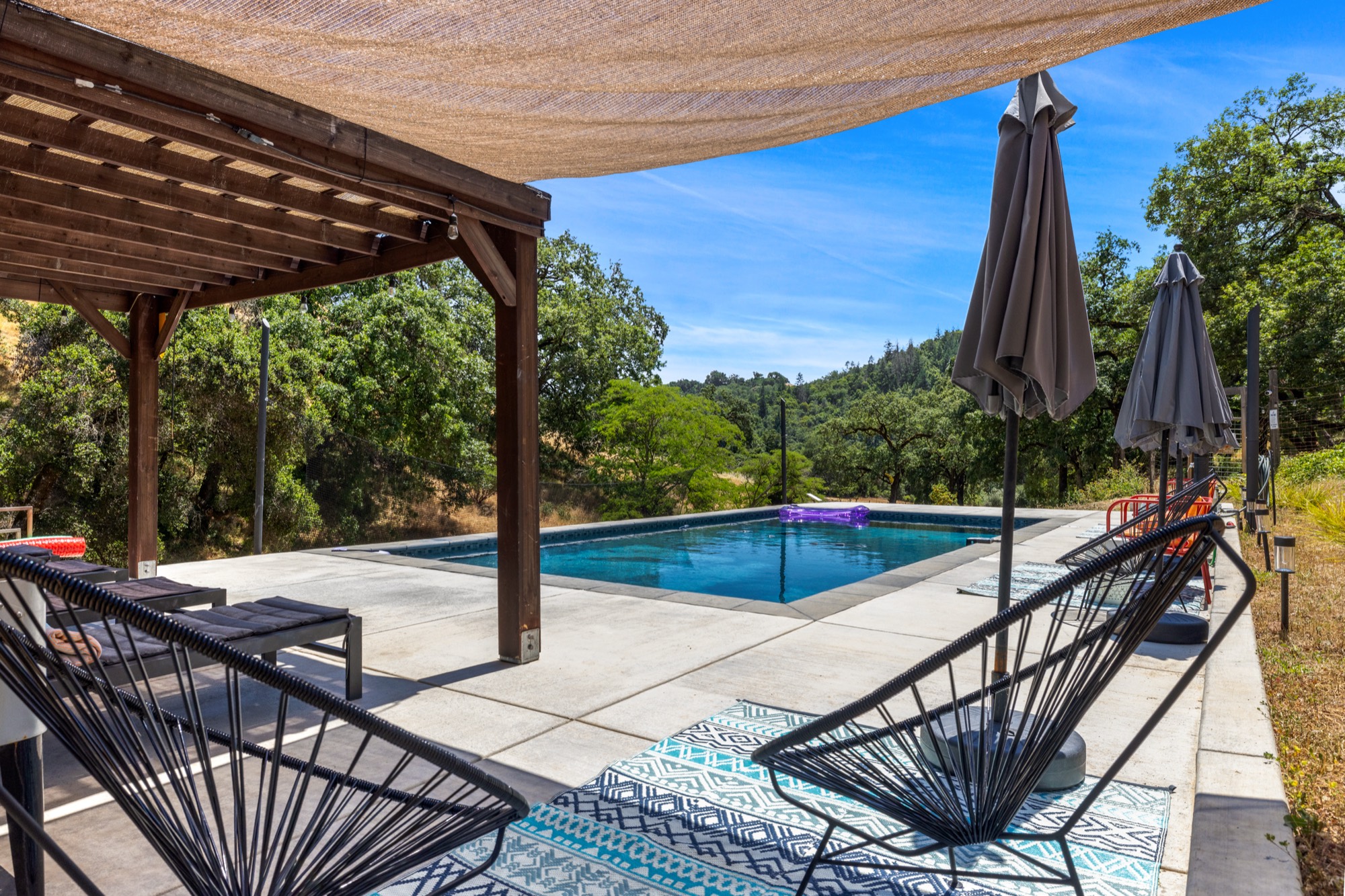 Pool lounge area with pergola