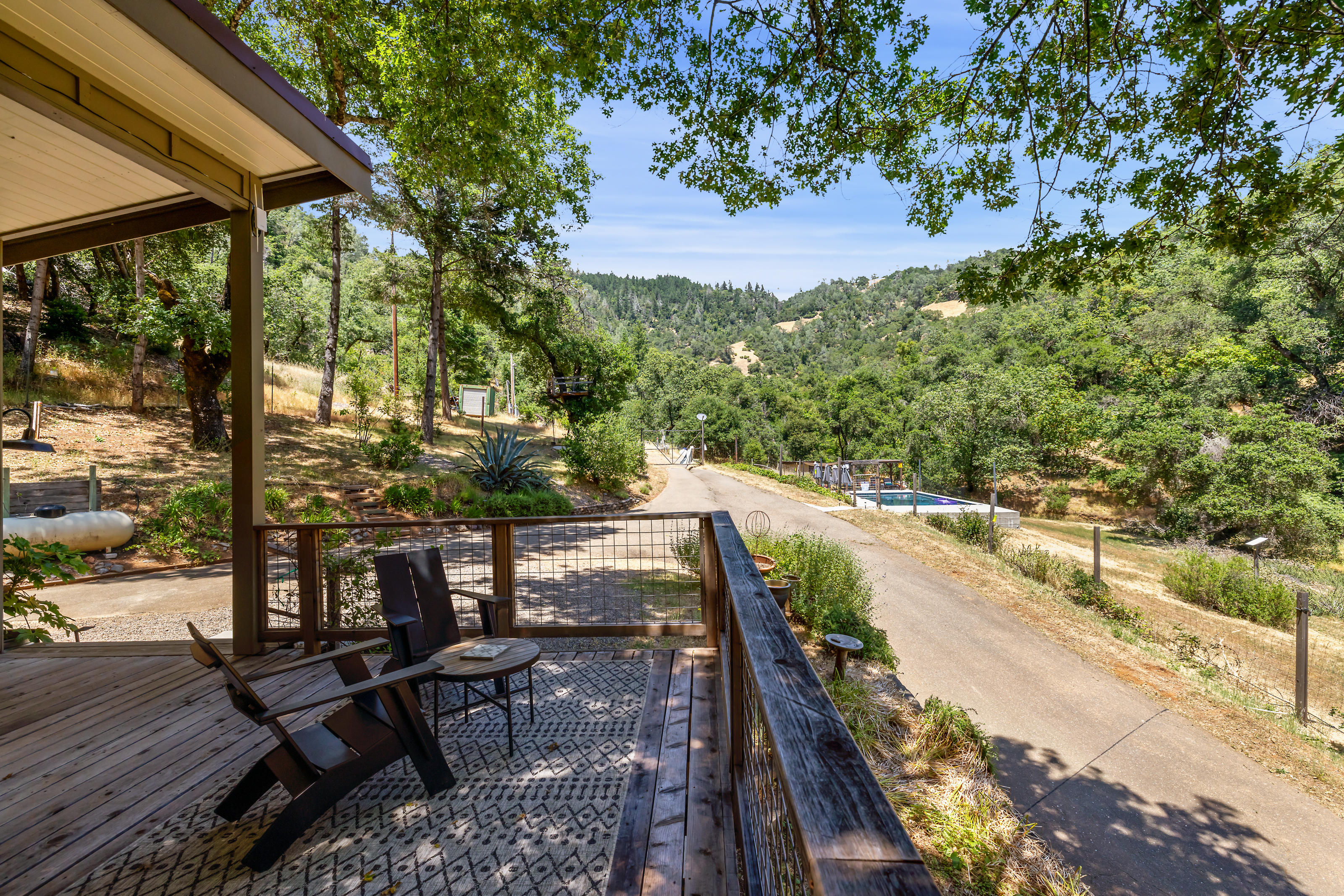Deck with views of pool and hillside