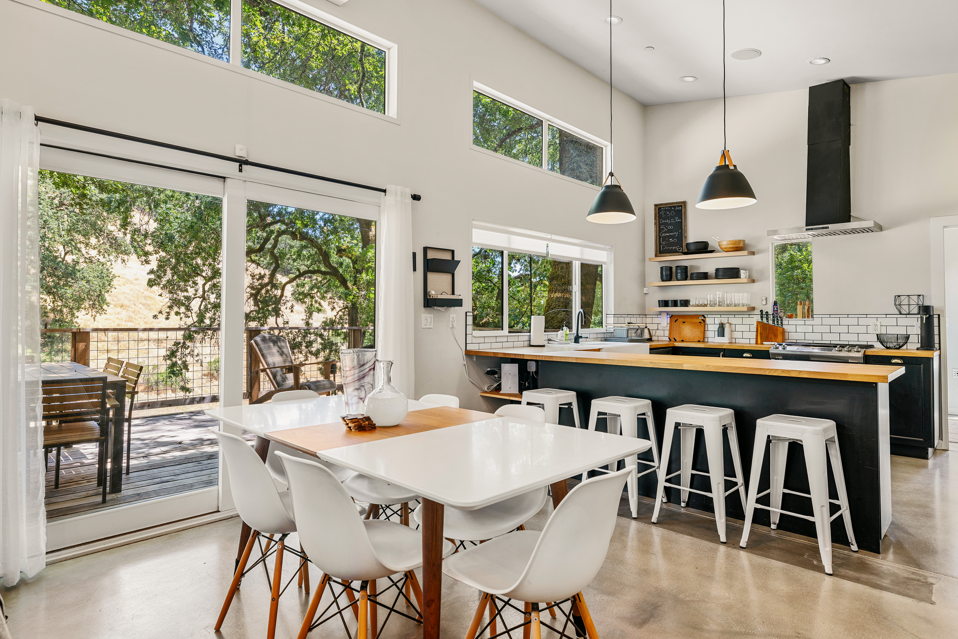Open floor plan with dining area, kitchen and deck views
